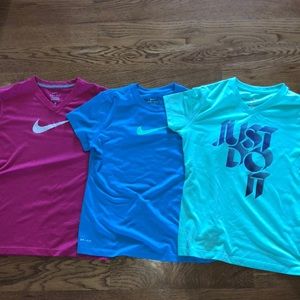 blue, mint green, and pink nike dri-fit t-shirts.